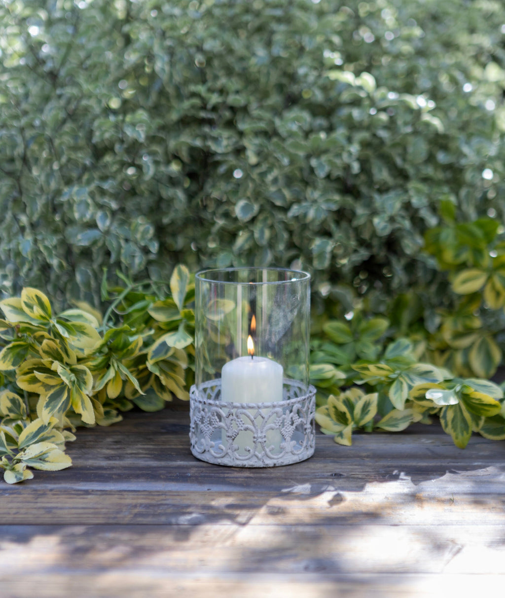 Rustic Glass Hurricane Lantern with Ornate Metal Base